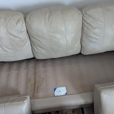 Sale Photo Thumbnail #6: Nice Lazy Boy Sofa, taupe in color, no tears or stains on the leather. The stain underneath the cushion is a water stain from a drink.