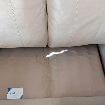 Sale Photo Thumbnail #25: Lazy Boy leather loveseat, taupe in color, no rips or stains on leather. The stain underneath the cushions is a water stain.