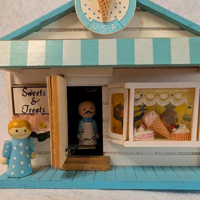 Sale Photo Thumbnail #412: St. Nicholas Square Village Ice Cream Shop Music Box 
As Music Play, the man comes out of the door and goes back in w/ door closing 
6x7x5