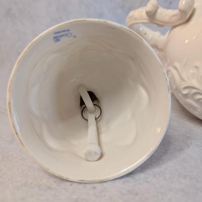 Sale Photo Thumbnail #454: Napcoware white teapot w/ lid and White Porcelain Flower girl bell 
Teapot: 7 x 8
Bell: 5.5 x 3