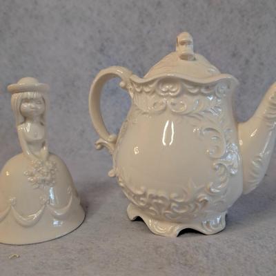 Sale Photo Thumbnail #456: Napcoware white teapot w/ lid and White Porcelain Flower girl bell 
Teapot: 7 x 8
Bell: 5.5 x 3