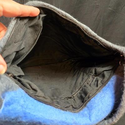 Sale Photo Thumbnail #459: This lot is for a Hand Made Felted  Grey Purse with Blue Cover and Floral Accents.  It has a very long shoulder strap.  Long enough to be knotted up to desired length.  With straps it measures about 38-inches long x 13-inches wide.  It does have a zippere