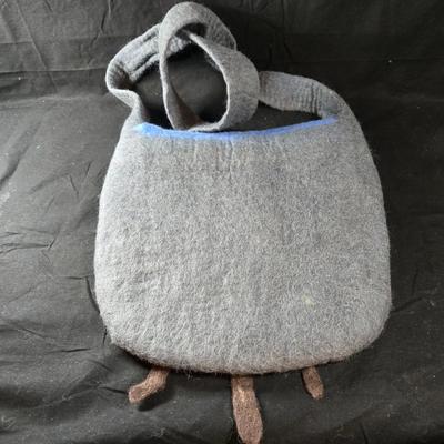 Sale Photo Thumbnail #458: This lot is for a Hand Made Felted  Grey Purse with Blue Cover and Floral Accents.  It has a very long shoulder strap.  Long enough to be knotted up to desired length.  With straps it measures about 38-inches long x 13-inches wide.  It does have a zippere
