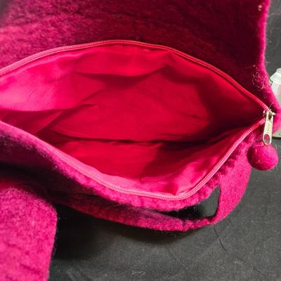 Sale Photo Thumbnail #467: This lot is for a Hand Made Felted Raspberry Colored Purse. It is actually darker than in the photo.  It is of a simple design with a felted box accent.  It has a zippered closer under the flap  It measures about 13-inches wide x 19-inches including strap