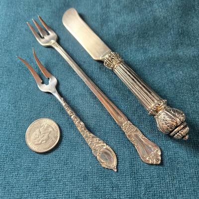 Sale Photo Thumbnail #475: This lot is for a grouping of Antique Serving Pieces.  This is a trio of antique serving pieces. Large fork is marked Wm A .Rogers, Oneida Ltd.  The butter knife is unmarked.  The small fork is marked Sterling and weighs about 8 grams.  All are in very go