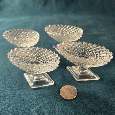 Sale Photo Thumbnail #480: This lot is for a grouping of Diamond Cut Footed Salt Cellars. This is a group of 4 salt cellars.  They are in very good shape, we found no chips or cracks.  They are unmarked and about 3-inches long. Would look nifty on the perfectly set table.