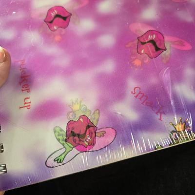 Sale Photo Thumbnail #501: This lot is for Spiral Bound New Journals. This is a pair of Spiral Bound Journals with unlined pages.  One has a Frogs and Kisses holographic cover and the other is a black background with sparkle dots like the night sky,  Unused.  They are both about 7-