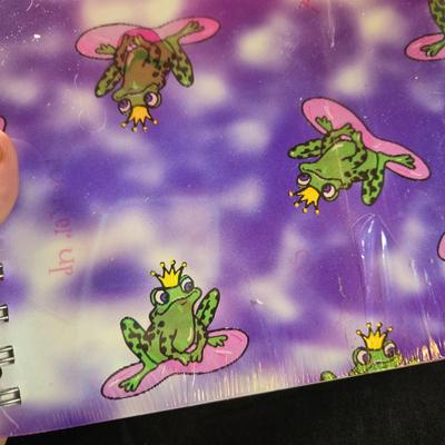 Sale Photo Thumbnail #502: This lot is for Spiral Bound New Journals. This is a pair of Spiral Bound Journals with unlined pages.  One has a Frogs and Kisses holographic cover and the other is a black background with sparkle dots like the night sky,  Unused.  They are both about 7-