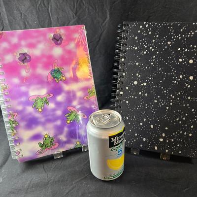 Sale Photo Thumbnail #500: This lot is for Spiral Bound New Journals. This is a pair of Spiral Bound Journals with unlined pages.  One has a Frogs and Kisses holographic cover and the other is a black background with sparkle dots like the night sky,  Unused.  They are both about 7-