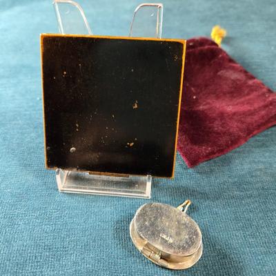 Sale Photo Thumbnail #506: This lot is for a Vintage Compact & Pill Box.   It is marked Elgin America. The design is Art Deco and the center is a large Mother of Pear square - very attractive.  Note that the compact does have a cracked mirror but otherwise in very good condition fo
