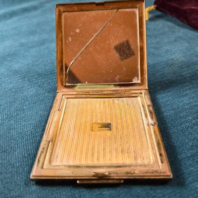 Sale Photo Thumbnail #512: This lot is for a Vintage Compact & Pill Box.   It is marked Elgin America. The design is Art Deco and the center is a large Mother of Pear square - very attractive.  Note that the compact does have a cracked mirror but otherwise in very good condition fo