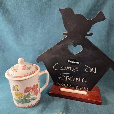 Sale Photo Thumbnail #519: This lot is for a Message Board and a Covered Mug for Spring Dreams. This is a small blackboard Message Board and a Spring motif Covered Coffee Mug.  The Chalkboard is made to fit the stand or it has a hanger if you wish to hang it. It is about 10-inches 