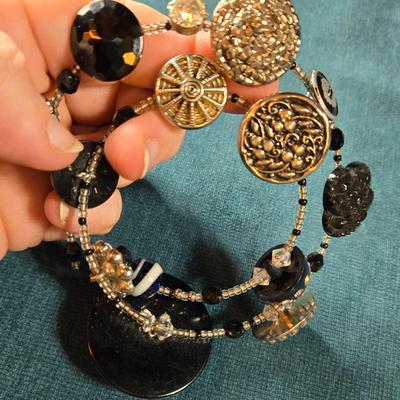 Sale Photo Thumbnail #524: This lot is for an Artist Hand Made Antique Button Bracelet. This is a very unique Hand Made Antique Button Bracelet by a local artist from St. James Art Fair.  It is a spiral wire design so it will fit anyone's wrist.  The old buttons have a wonderful lo