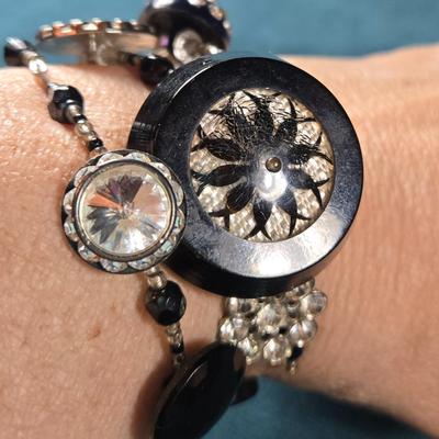 Sale Photo Thumbnail #525: This lot is for an Artist Hand Made Antique Button Bracelet. This is a very unique Hand Made Antique Button Bracelet by a local artist from St. James Art Fair.  It is a spiral wire design so it will fit anyone's wrist.  The old buttons have a wonderful lo