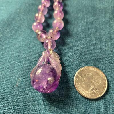 Sale Photo Thumbnail #534: This lot is for a Show Stopper Amethyst Necklace w/14K Gold Clasp. This is a stunning Amethyst Necklace.  The Beads are individually hand knotted in between and the main drop is hand carved.  The beads vary sequentially from large to small to the 14K Gold