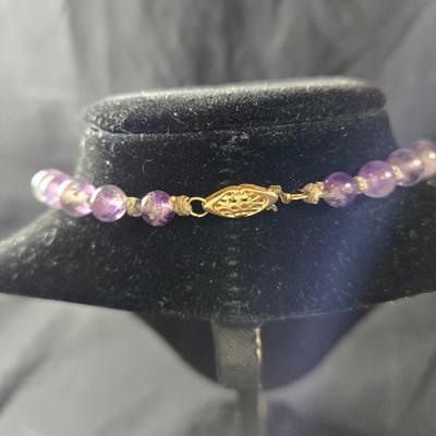 Sale Photo Thumbnail #530: This lot is for a Show Stopper Amethyst Necklace w/14K Gold Clasp. This is a stunning Amethyst Necklace.  The Beads are individually hand knotted in between and the main drop is hand carved.  The beads vary sequentially from large to small to the 14K Gold