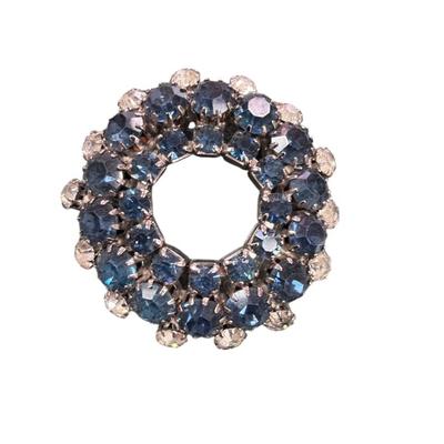 Sale Photo Thumbnail #486: Vintage Silver Toned Rhinestone Wreath Brooch Featuring Concentric Circles of Blue and Clear Crystal