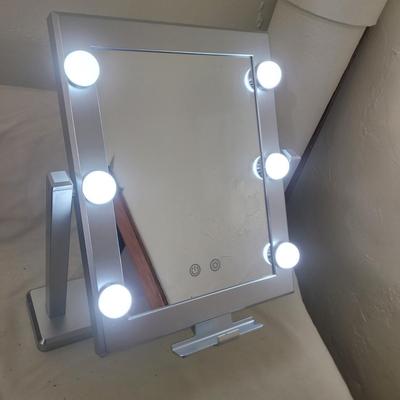 Sale Photo Thumbnail #618: Mirror mirror on the counter. Works, takes 4 AA batteries. Has differing hues for the bulbs, natural, soft and daylight.
