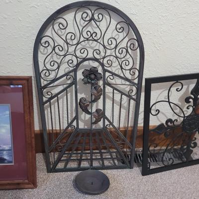 Sale Photo Thumbnail #693: Tge rounded top iron wall decoration is a candle holder