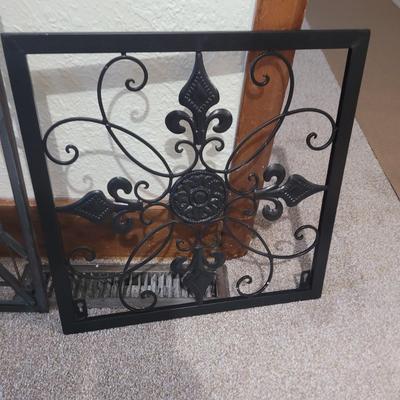 Sale Photo Thumbnail #694: Tge rounded top iron wall decoration is a candle holder