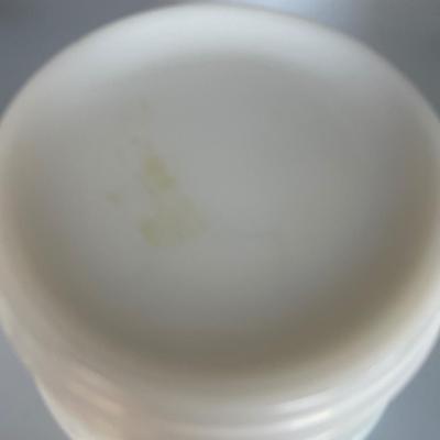 White milk glass mixing bowl with green depression glass cup and blue fiesta style cup