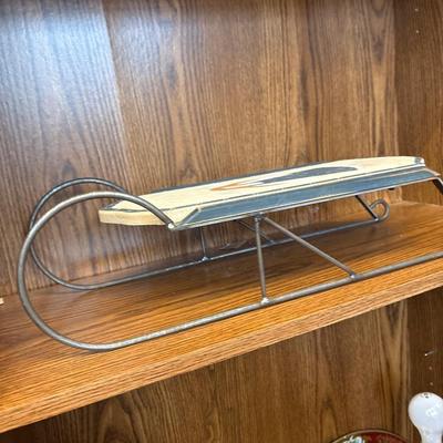 Large basket, milk glass lamp, metal trays, and sled