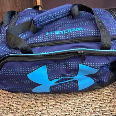 Under Armour duffel bag, elephant duffel bag, and two smaller bags