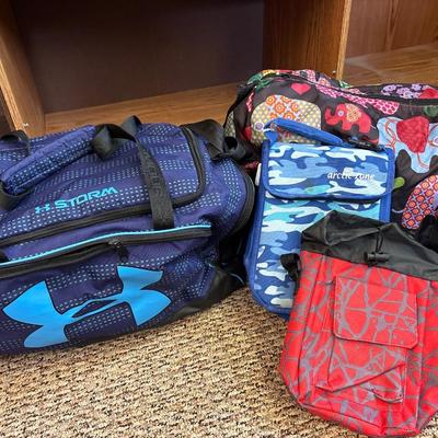 Under Armour duffel bag, elephant duffel bag, and two smaller bags
