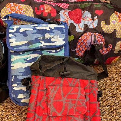 Under Armour duffel bag, elephant duffel bag, and two smaller bags