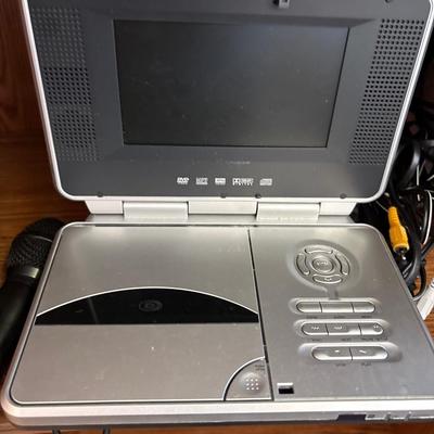 Portable DVD player with cords, microphones, and more