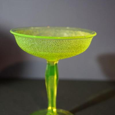 Sale Photo Thumbnail #14: At auction a Tiffin glass compote in the Jack Frost pattern. 
The compote glows under black light. Uranium glass.

Prism pressed cut pattern stem. 
This is a three mold pattern piece. 

Height: 7 1/2"
opening at the top: 6 1/2" 

Condtion: the stem from t