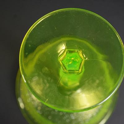 Sale Photo Thumbnail #12: At auction a Tiffin glass compote in the Jack Frost pattern. 
The compote glows under black light. Uranium glass.

Prism pressed cut pattern stem. 
This is a three mold pattern piece. 

Height: 7 1/2"
opening at the top: 6 1/2" 

Condtion: the stem from t