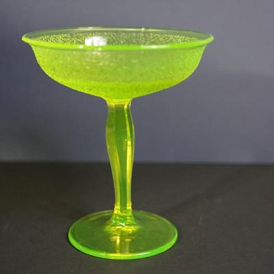 Sale Photo Thumbnail #9: At auction a Tiffin glass compote in the Jack Frost pattern. 
The compote glows under black light. Uranium glass.

Prism pressed cut pattern stem. 
This is a three mold pattern piece. 

Height: 7 1/2"
opening at the top: 6 1/2" 

Condtion: the stem from t