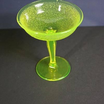 Sale Photo Thumbnail #10: At auction a Tiffin glass compote in the Jack Frost pattern. 
The compote glows under black light. Uranium glass.

Prism pressed cut pattern stem. 
This is a three mold pattern piece. 

Height: 7 1/2"
opening at the top: 6 1/2" 

Condtion: the stem from t