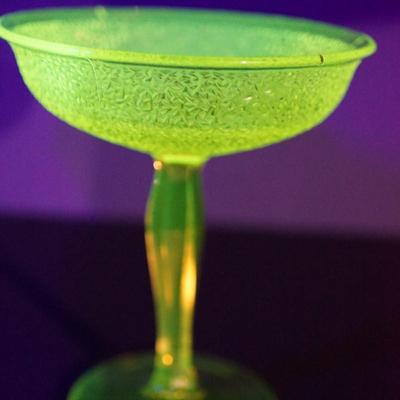 Sale Photo Thumbnail #13: At auction a Tiffin glass compote in the Jack Frost pattern. 
The compote glows under black light. Uranium glass.

Prism pressed cut pattern stem. 
This is a three mold pattern piece. 

Height: 7 1/2"
opening at the top: 6 1/2" 

Condtion: the stem from t