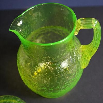 Sale Photo Thumbnail #17: Lot 3

Original vaseline glass pitcher with lid. 
Maker unknown, Tiffin , L.E Smith, / not marked and no match found

The yellow glass has a green hue
glows with black light uranium glass
Height of pitcher base to the finail on lid :10"
Width at the cente