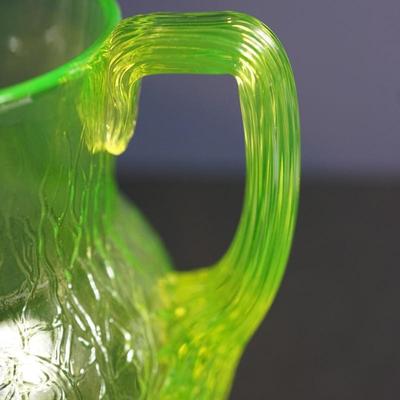 Sale Photo Thumbnail #18: Lot 3

Original vaseline glass pitcher with lid. 
Maker unknown, Tiffin , L.E Smith, / not marked and no match found

The yellow glass has a green hue
glows with black light uranium glass
Height of pitcher base to the finail on lid :10"
Width at the cente