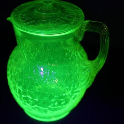 Sale Photo Thumbnail #20: Lot 3

Original vaseline glass pitcher with lid. 
Maker unknown, Tiffin , L.E Smith, / not marked and no match found

The yellow glass has a green hue
glows with black light uranium glass
Height of pitcher base to the finail on lid :10"
Width at the cente