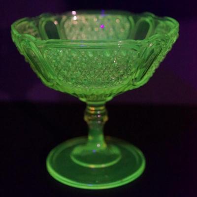 Sale Photo Thumbnail #29: Circa 1880-1890;s 
Antique pressed pattern compote of just under 7" in height. the bowl has a height of approximate 4" deep
turned glass pedestal with bowl of Daisy & Button pattern panelled sides. 
very well designed. 
UV light fluorescent 

there is a v