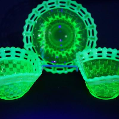 Sale Photo Thumbnail #37: At auction is a grouping of three Fenton candy dishes in the basket weave pattern, 
Lacy edge of opalescent glass. 
Mold blown 
early 1930's 
Uranium content glows under UV light 

round bowl measures: 7" across the top 
Height : 1 3/4" 
condition; very g