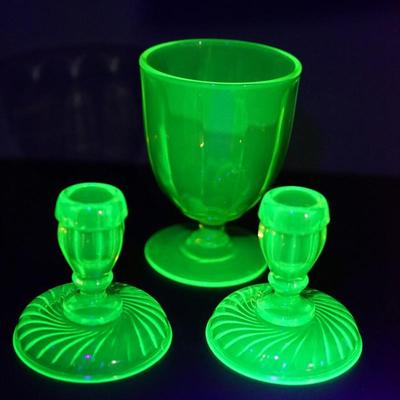 Sale Photo Thumbnail #52: 1930's vaseline glass footed candy dish, no lid. The  rim  has rounded edge so maybe did not have a lid orginal just over 5" and in good condition 
the candleholders are 4" in height, good condition 
UV light fluorescent