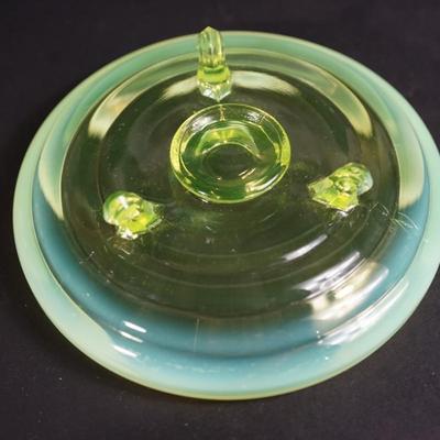 Sale Photo Thumbnail #72: 6" low bowl of 2" in height . Vaseline glass with an opalescent rim,
tiered rib pattern  
three mold blown glass
footed(3) 
good condition. Slight scratches inside but not bad. 
UV light tested fluorescent
