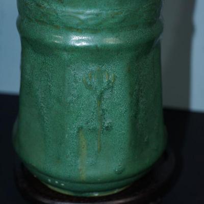 Sale Photo Thumbnail #99: Early 1900's Zanesville pottery vase. 
Matt Green, panelled sides with a flower on every other panel. 
No factory marks found. 
Height: 7 1/4" 
Opening: 4 3/4" 
condition. Good. no cracks or chips noted. There are a tiny specks of where sand from the kiln