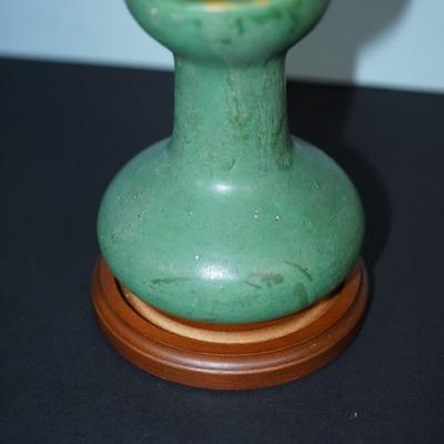 Sale Photo Thumbnail #104: Zanesville Ohio green matt green glazed vase. 
Height just under 6" at 5 3/4"
"corsette waste with bulbous base . 
Marked 60 on the base. 
There are stains in areas of the glaze, see photos. 
slight wear around the rim and or where the glaze did not take.
