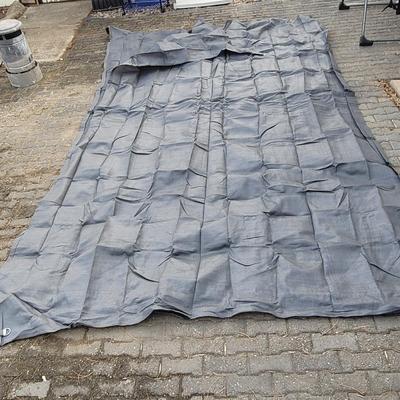 Sale Photo Thumbnail #1006: This is a grey, breathable camping groundsheet or awning carpet. 
It is made from a durable, non-perishable woven material that allows air and moisture to pass through. 
The tight weave acts as an effective barrier to insects and worms while protecting th