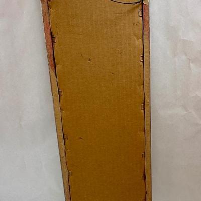 Tall, Slender framed art Monk holding a cross with Mission in background