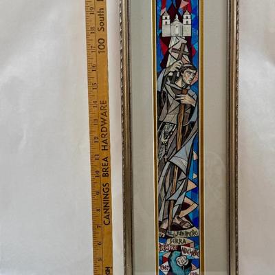 Tall, Slender framed art Monk holding a cross with Mission in background