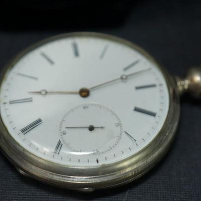 Sale Photo Thumbnail #121: antique pocket watch. silverplated /case coin? 
Case: 52810
no markings found inside the works, 
bezel and crystal intact and in good condition 
key wind- key is missing, 
The watch is selling as is. Not working 
engraved case of trees and cottage on one 