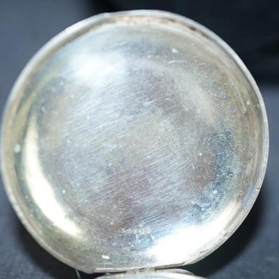 Sale Photo Thumbnail #123: antique pocket watch. silverplated /case coin? 
Case: 52810
no markings found inside the works, 
bezel and crystal intact and in good condition 
key wind- key is missing, 
The watch is selling as is. Not working 
engraved case of trees and cottage on one 