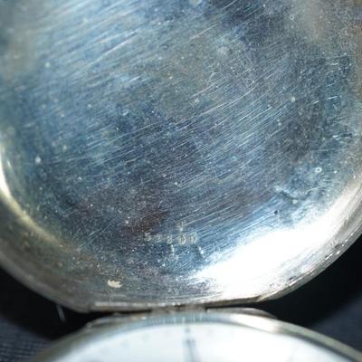 Sale Photo Thumbnail #122: antique pocket watch. silverplated /case coin? 
Case: 52810
no markings found inside the works, 
bezel and crystal intact and in good condition 
key wind- key is missing, 
The watch is selling as is. Not working 
engraved case of trees and cottage on one 